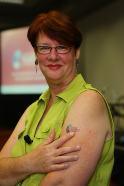 Cheryl Gorman, vice president of national programs at the Harwood Institute, points to her tattoo (Photo: Cognotes)