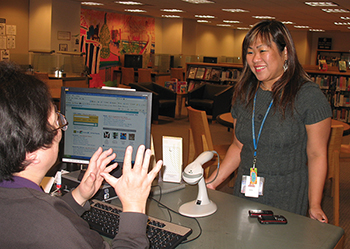 Leah Esquerra (right) is a social worker at San Francisco Public Library. She helps provide support to homeless patrons who gather at the library.