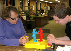 Library director LeAnn Dean (left) battles it out with another gamer at a Rock ’Em Sock ’Em Robots match. (Photo: Rodney A. Briggs Library)